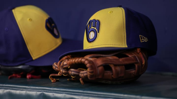 Jul 28, 2023; Atlanta, Georgia, USA; A detailed view of a Milwaukee Brewers hat and glove on the bench against the Atlanta Braves in the second inning at Truist Park. Mandatory Credit: Brett Davis-USA TODAY Sports