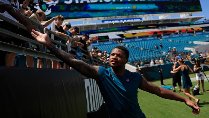 Jacksonville Jaguars cornerback Tyson Campbell (32) greets fans during the ninth day of an NFL football training camp practice Saturday, Aug. 3, 2024 at EverBank Stadium in Jacksonville, Fla. Today marked the first day of public practice inside the stadium.