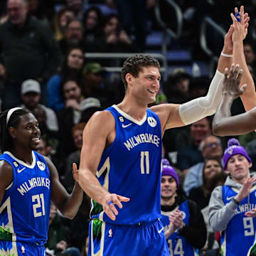 Dec 7, 2022; Milwaukee, Wisconsin, USA; Milwaukee Bucks center Brook Lopez (11) celebrates with Milwaukee Bucks guard Jrue Holiday (21) and forward Khris Middleton (22) after a score in the fourth quarter during game against Sacramento Kings at Fiserv Forum. Mandatory Credit: Benny Sieu-Imagn Images