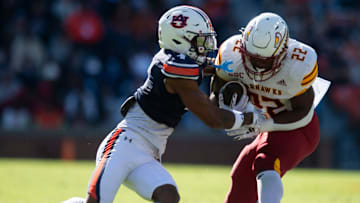 Louisiana-Monroe Warhawks running back Ahmad Hardy (22) breaks a tackle attempt from Auburn Tigers defensive back Kayin Lee (4) as Auburn Tigers take on Louisiana-Monroe Warhawks at Jordan-Hare Stadium in Auburn, Ala., on Saturday, Nov. 16, 2024. Auburn Tigers lead Louisiana-Monroe Warhawks 24-0 at halftime.