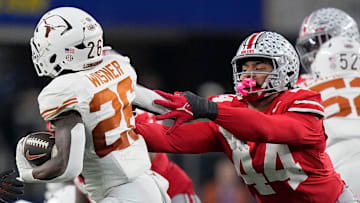 Ohio State Buckeyes defensive end JT Tuimoloau tries to bring down Texas Longhorns running back Quintrevion Wisner in the College Football Playoff semifinal 