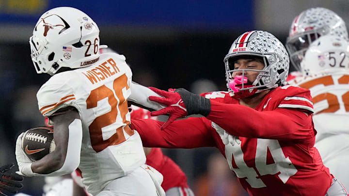 Ohio State Buckeyes defensive end JT Tuimoloau tries to bring down Texas Longhorns running back Quintrevion Wisner in the College Football Playoff semifinal 