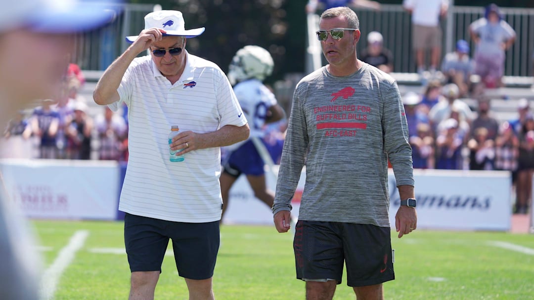 Terry Pegula, owner, CEO, and president of the Buffalo Bills, and Brandon Beane, general manager, talk and walk off the field at the end of practice.