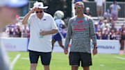 Terry Pegula, owner, CEO, and president of the Buffalo Bills, and Brandon Beane, general manager, talk and walk off the field at the end of practice.