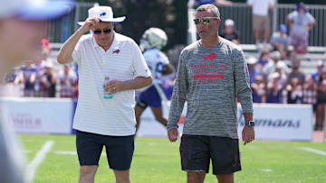 Terry Pegula, owner, CEO, and president of the Buffalo Bills, and Brandon Beane, general manager, talk and walk off the field at the end of practice.