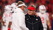 Nov 11, 2023; Athens, Georgia, USA; Mississippi Rebels head coach Lane Kiffin talks to Georgia Bulldogs head coach Kirby Smart before a game at Sanford Stadium. Mandatory Credit: Brett Davis-Imagn Images