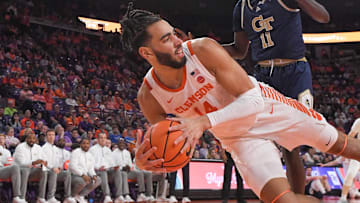 Clemson center Christian Reeves (14) saves a ball near Georgia Tech forward Baye Ndongo (11) during the first half at Littlejohn Coliseum in Clemson, S.C. Tuesday, February 4, 2025.