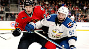 Coachella Valley Firebirds forward Ryan Winterton (27), left, and Colorado Eagles forward Cedric Pare (65) battle for the puck at Acrisure Arena in Palm Desert, Calif., on Sun., Dec. 17, 2023.
