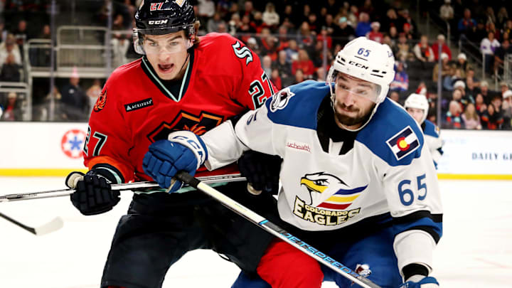 Coachella Valley Firebirds forward Ryan Winterton (27), left, and Colorado Eagles forward Cedric Pare (65) battle for the puck at Acrisure Arena in Palm Desert, Calif., on Sun., Dec. 17, 2023. Coachella Valley Firebirds forward Ryan Winterton (27), left, and Colorado Eagles forward Cedric Pare (65) battle for the puck at Acrisure Arena in Palm Desert, Calif., on Sun., Dec. 17, 2023.