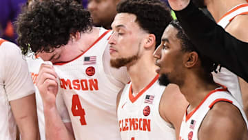 Clemson senior forward Ian Schieffelin (4), left, Clemson guard Hunter (1) and guard Dillon Hunter (2) during the alma mater song after losing the game to Georgia Tech 89-86 at Littlejohn Coliseum in Clemson, S.C. Tuesday, February 4, 2025.