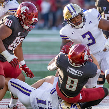 Buddah Al-Uqdah and Alex McLaughlin make an Apple Cup tackle.