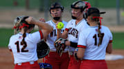 Baker County's Chloe Woods (8), center right, talks to teammates during the fourth inning of a regular season high school softball matchup Tuesday, April 23, 2024 at Baker County High School in Glen St. Mary, Fla. The Baker County Wildcats defeated the Middleburg Broncos 6-3.
