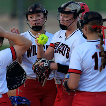 Baker County's Chloe Woods (8), center right, talks to teammates during the fourth inning of a regular season high school softball matchup Tuesday, April 23, 2024 at Baker County High School in Glen St. Mary, Fla. The Baker County Wildcats defeated the Middleburg Broncos 6-3.