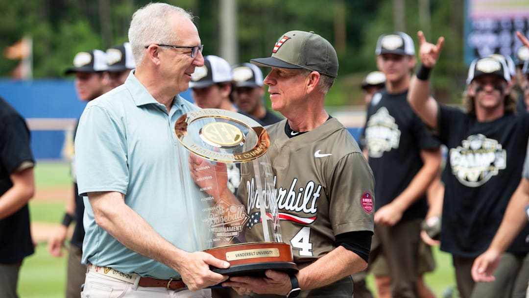 SEC Commissioner Greg Sankey presents the trophy to Vanderbilt Commodores head coach Tim Corbin as Ole Miss Rebels take on Vanderbilt Commodores during the SEC baseball tournament championship game at Hoover Met in Birmingham, Ala., on Sunday, May 25, 2025. Vanderbilt Commodores defeated Ole Miss Rebels 3-2.