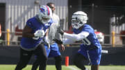 Bills Dawuane Smoot tries to get away from Von Miller during an edge drill.