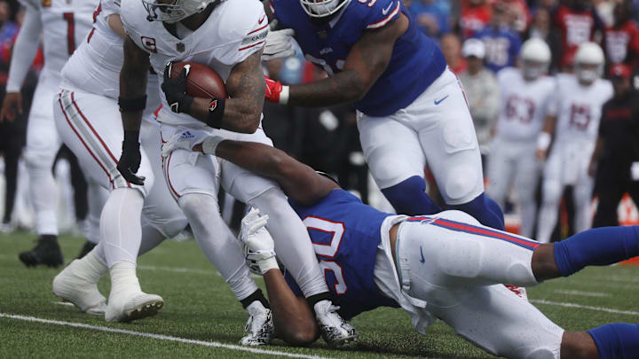 Arizona's James Conner carries the ball before getting taken down by Bills Greg Rousseau during first half action at Highmark Stadium in Orchard Park on Sept. 8, 2024. Coming up to help out Rousseau is teammate DaQuan Jones.