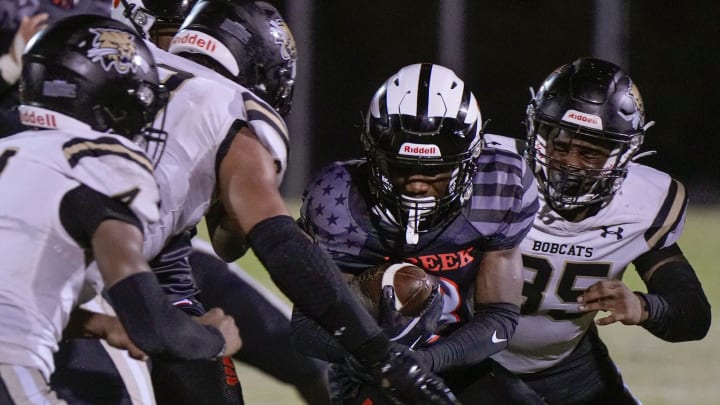 Spruce Creek's Denali Campbell attempts to run through Buchholz defense during a preseason game with at Spruce Creek High School, Thursday, Aug.15, 2024.