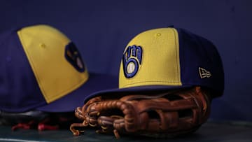 Jul 28, 2023; Atlanta, Georgia, USA; A detailed view of a Milwaukee Brewers hat and glove on the bench against the Atlanta Braves in the second inning at Truist Park. Mandatory Credit: Brett Davis-Imagn Images