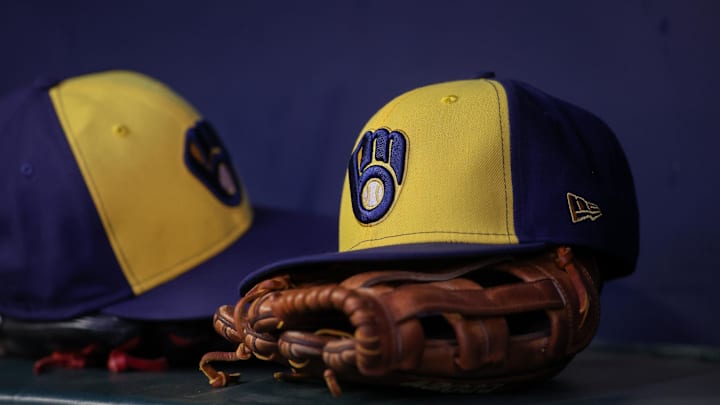 Jul 28, 2023; Atlanta, Georgia, USA; A detailed view of a Milwaukee Brewers hat and glove on the bench against the Atlanta Braves in the second inning at Truist Park. Mandatory Credit: Brett Davis-Imagn Images