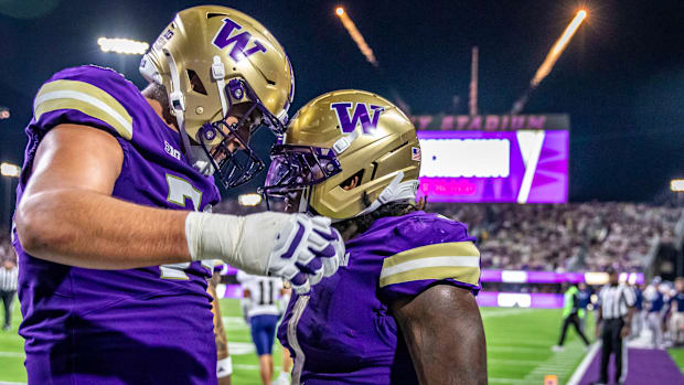 Right tackle Drew Azzopardi and Jonah Coleman share a moment amid all the touchdown runs. 