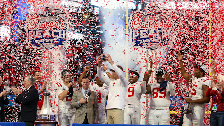 Dec 30, 2023; Atlanta, GA, USA; Mississippi Rebels head coach Lane Kiffin holds up the Peach Bowl