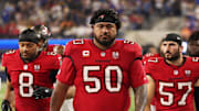 Tampa Bay Buccaneers defensive tackle Vita Vea (50) walks off the field during halftime with linebacker SirVocea Dennis (8), linebacker John Bullock (57) and safety Tykee Smith (23)