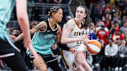 Indiana Fever guard Caitlin Clark (22) dribbles  the ball while New York Liberty guard Natasha Cloud (9) defends in the second half at Gainbridge Fieldhouse.