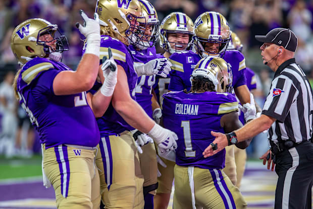 The Husky offensive line celebrates a Jonah Coleman touchdown. 