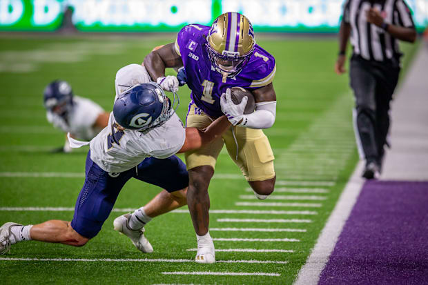 Jonah Coleman takes on a UC Davis tackler. 