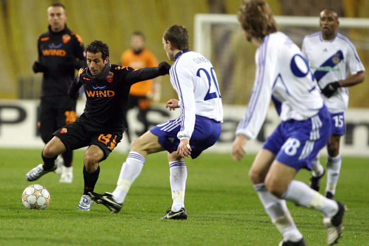 Ludovic Giuly of AS Roma (L) vies for th
