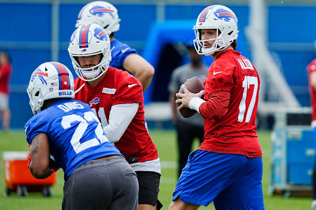 Buffalo Bills QB Josh Allen gets ready to throw to a receiver while backup QB Mitchell Trubisky hands off the ball 