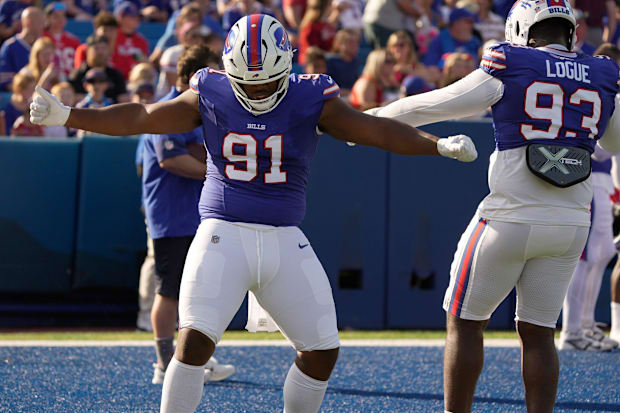 Buffalo Bills DTs Ed Oliver and Zion Logue dance to the music for a few moments while waiting for their turn to run a drill.