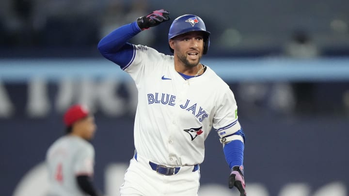 Toronto Blue Jays designated hitter George Springer (4) celebrates his two-run home run against the Cincinnati Reds as he rounds the bases during the second inning at Rogers Centre on Aug 20.