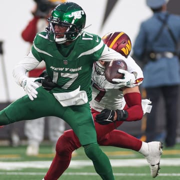 Dec 24, 2023; East Rutherford, New Jersey, USA; New York Jets wide receiver Garrett Wilson (17) is tackled by Washington Commanders linebacker Cody Barton (57) during the second half at MetLife Stadium.