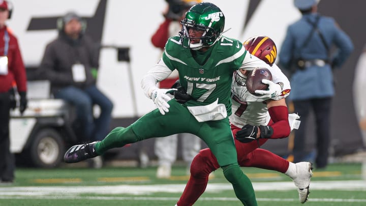 Dec 24, 2023; East Rutherford, New Jersey, USA; New York Jets wide receiver Garrett Wilson (17) is tackled by Washington Commanders linebacker Cody Barton (57) during the second half at MetLife Stadium.