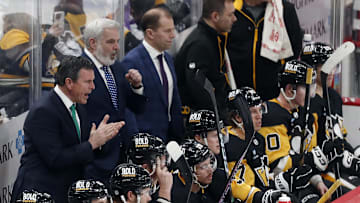 Mar 16, 2024; Pittsburgh, Pennsylvania, USA; Pittsburgh Penguins head coach Mike Sullivan (rear left) reacts on he bench against the New York Rangers during the third period at PPG Paints Arena. New York won 7-4.  Mandatory Credit: Charles LeClaire-Imagn Images