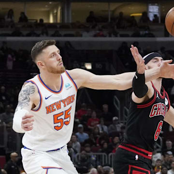 Apr 5, 2024; Chicago, Illinois, USA; Chicago Bulls guard Alex Caruso (6) and New York Knicks center Isaiah Hartenstein (55) go for the ball during the second half at United Center