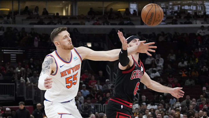 Apr 5, 2024; Chicago, Illinois, USA; Chicago Bulls guard Alex Caruso (6) and New York Knicks center Isaiah Hartenstein (55) go for the ball during the second half at United Center