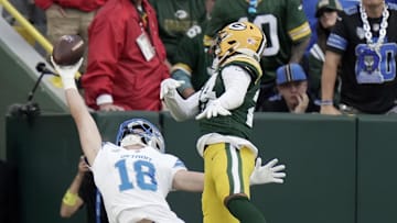 Sep 7, 2025; Green Bay, Wisconsin, USA; Detroit Lions wide receiver Isaac TeSlaa (18) catches a touchdown pass while being covered by Green Bay Packers cornerback Carrington Valentine (24) during the fourth quarter at Lambeau Field. The play was originally ruled incomplete but the call was overturned Mandatory Credit: Mark Hoffman-USA TODAY Network via Imagn Images