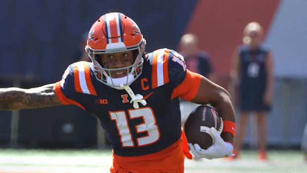 Illinois Fighting Illini wide receiver Pat Bryant stiff arms Central Michigan Chippewas defensive lineman Jaden Davis.