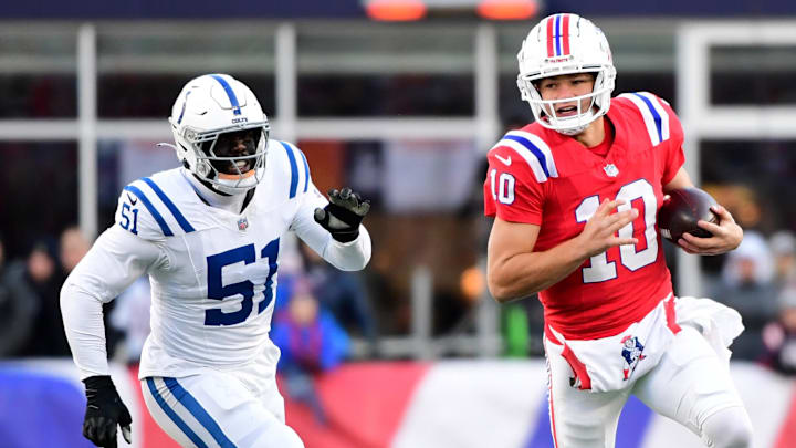Dec 1, 2024; Foxborough, Massachusetts, USA;  New England Patriots quarterback Drake Maye (10) runs the ball while Indianapolis Colts defensive end Kwity Paye (51) defends during the second half at Gillette Stadium. Mandatory Credit: Bob DeChiara-Imagn Images