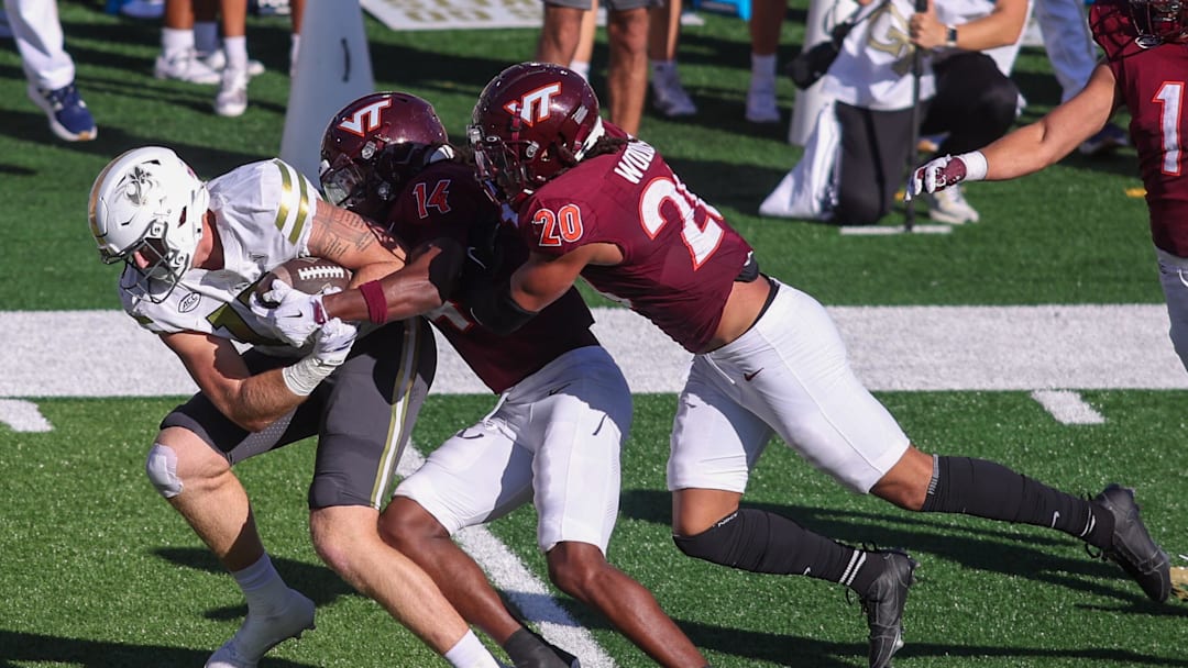 Oct 11, 2025; Atlanta, Georgia, USA; Georgia Tech Yellow Jackets tight end Josh Beetham (17) is tackled by Virginia Tech Hokies safety Sheldon Robinson (14) and linebacker Caleb Woodson (20) in the second quarter at Bobby Dodd Stadium at Hyundai Field. Mandatory Credit: Brett Davis-Imagn Images
