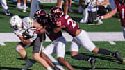 Oct 11, 2025; Atlanta, Ga.; Georgia Tech tight end Josh Beetham (17) is tackled by Virginia Tech safety Sheldon Robinson (14) and linebacker Caleb Woodson (20).