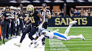 Sep 8, 2024; New Orleans, Louisiana, USA;  Carolina Panthers safety Jordan Fuller (20) pushes New Orleans Saints running back Alvin Kamara (41) out of bounds during the second half at Caesars Superdome. Mandatory Credit: Stephen Lew-Imagn Images