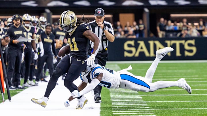 Sep 8, 2024; New Orleans, Louisiana, USA;  Carolina Panthers safety Jordan Fuller (20) pushes New Orleans Saints running back Alvin Kamara (41) out of bounds during the second half at Caesars Superdome. Mandatory Credit: Stephen Lew-Imagn Images