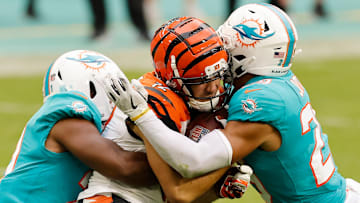 Miami Dolphins defenders tackle Cincinnati Bengals WR