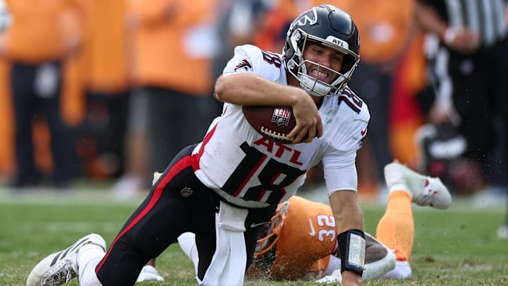 Oct 27, 2024; Tampa, Florida, USA; Atlanta Falcons quarterback Kirk Cousins (18) is brought down by Tampa Bay Buccaneers safety Josh Hayes (32) in the fourth quarter at Raymond James Stadium. Mandatory Credit: Nathan Ray Seebeck-Imagn Images