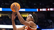 Texas A&M Aggies guard Manny Obaseki (35) guards while Texas Longhorns guard Tre Johnson (20) goes up for a layup during their second round game of the SEC Men's Basketball Tournament at Bridgestone Arena in Nashville, Tenn., Thursday, March 13, 2025.