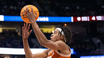 Texas A&M Aggies guard Manny Obaseki (35) guards while Texas Longhorns guard Tre Johnson (20) goes up for a layup during their second round game of the SEC Men's Basketball Tournament at Bridgestone Arena in Nashville, Tenn., Thursday, March 13, 2025.