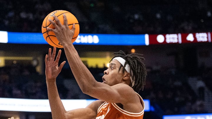 Texas A&M Aggies guard Manny Obaseki (35) guards while Texas Longhorns guard Tre Johnson (20) goes up for a layup during their second round game of the SEC Men's Basketball Tournament at Bridgestone Arena in Nashville, Tenn., Thursday, March 13, 2025. Texas A&M Aggies guard Manny Obaseki (35) guards while Texas Longhorns guard Tre Johnson (20) goes up for a layup during their second round game of the SEC Men's Basketball Tournament at Bridgestone Arena in Nashville, Tenn., Thursday, March 13, 2025.